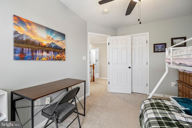 bedroom featuring light colored carpet, a closet, and ceiling fan