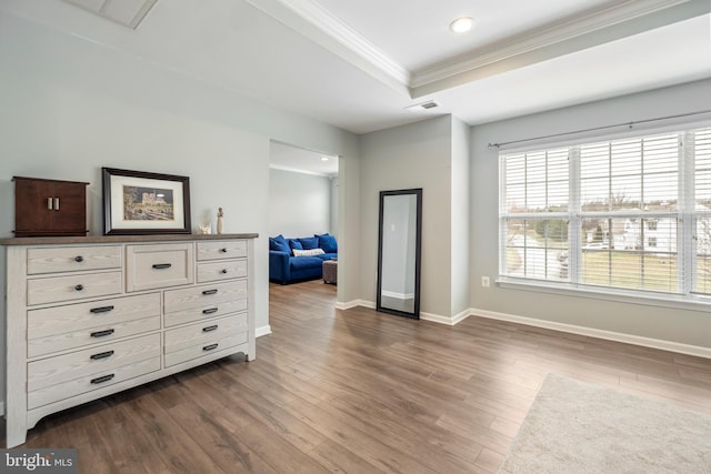 interior space with crown molding, a tray ceiling, and dark hardwood / wood-style floors