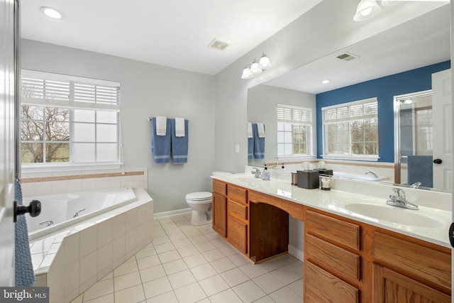 bathroom with vanity, a relaxing tiled tub, tile patterned floors, and toilet