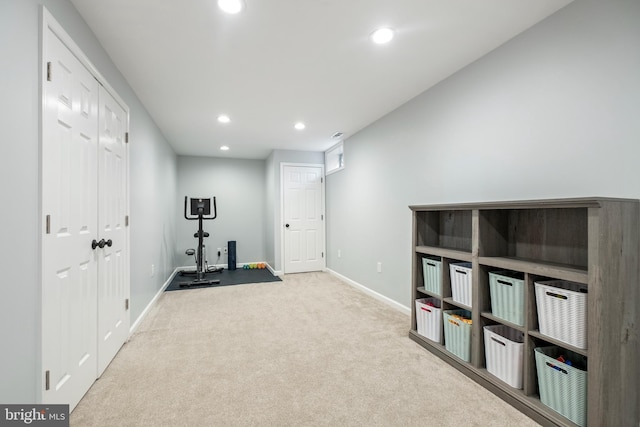 workout area featuring light carpet