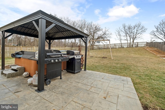 view of patio / terrace featuring a hot tub, a gazebo, and a grill