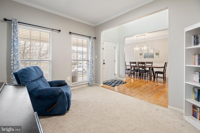 living area with crown molding and light carpet