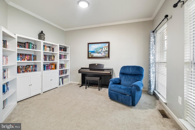 sitting room with crown molding and light colored carpet