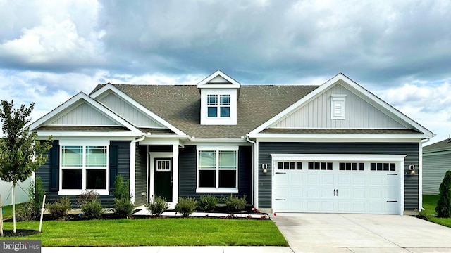 craftsman-style home with a front yard and a garage