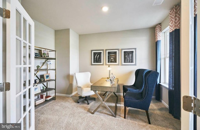 carpeted office space with french doors