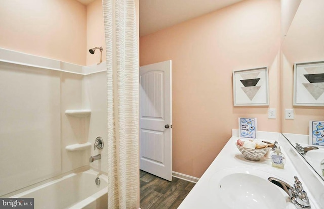 bathroom with hardwood / wood-style floors, vanity, and shower / tub combo with curtain