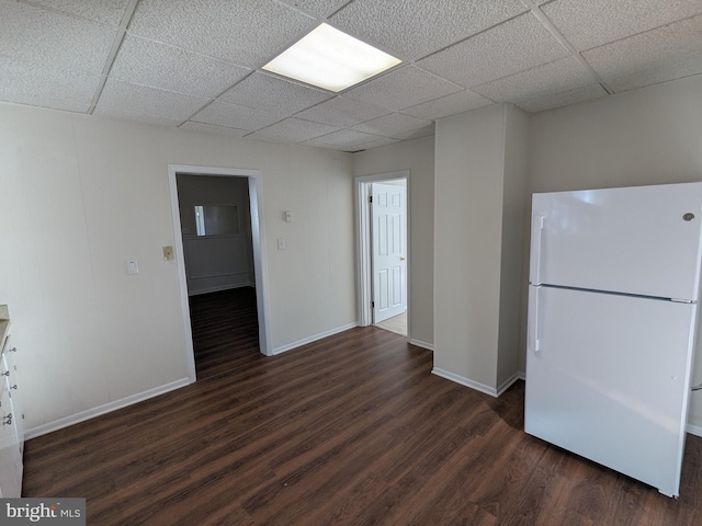 kitchen with a paneled ceiling, dark hardwood / wood-style floors, and white refrigerator