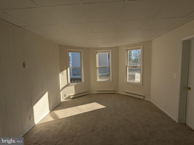 unfurnished room featuring carpet and a baseboard radiator