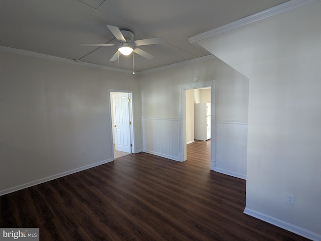 empty room featuring ceiling fan, dark wood-type flooring, and ornamental molding