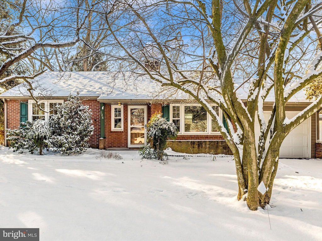 ranch-style house with a garage and brick siding