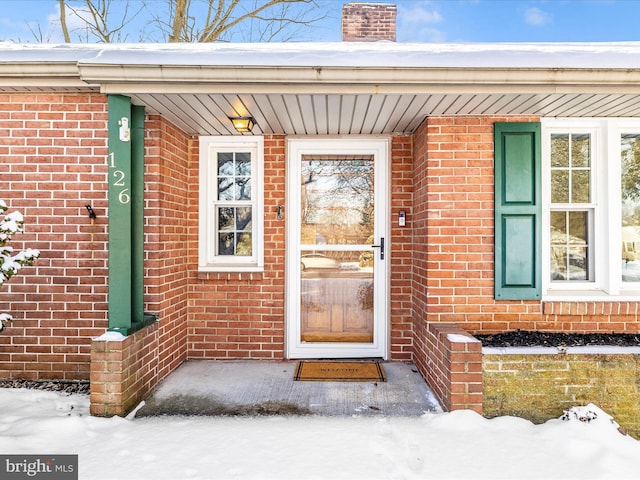 view of snow covered property entrance