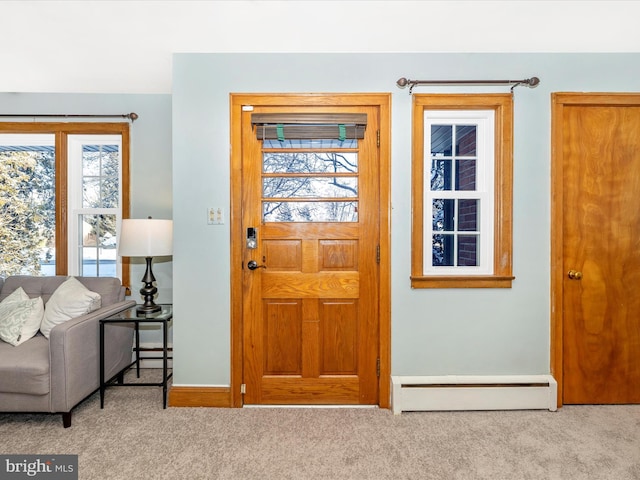 carpeted entrance foyer featuring baseboard heating