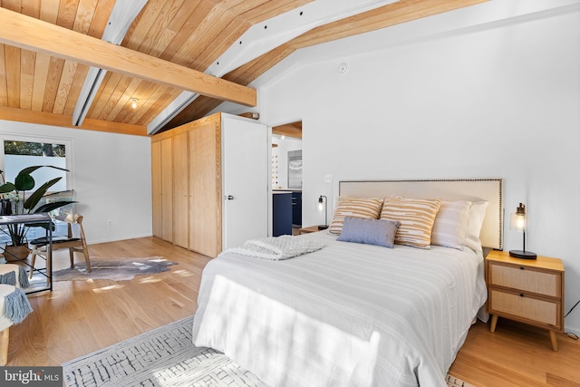 bedroom with lofted ceiling with beams, wood finished floors, and wood ceiling