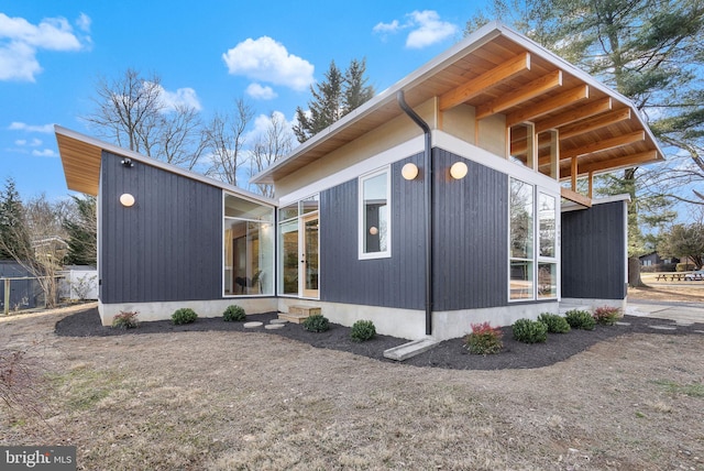 view of side of property featuring a sunroom