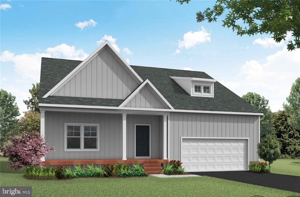 view of front of home with a front yard and a garage