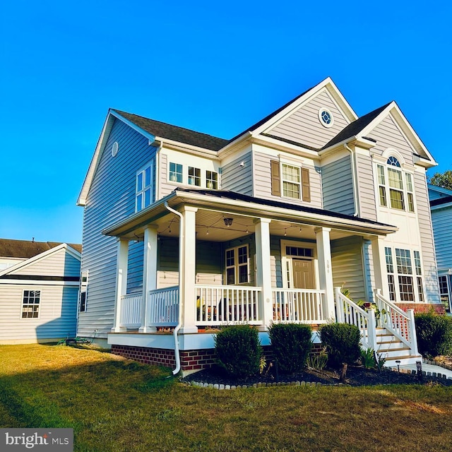 view of front of property featuring a front lawn and covered porch