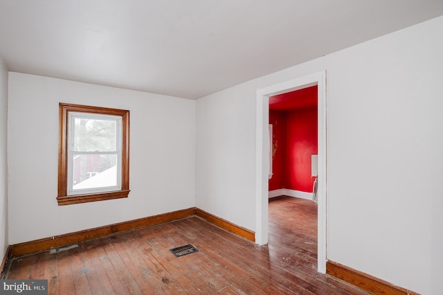 empty room with hardwood / wood-style flooring