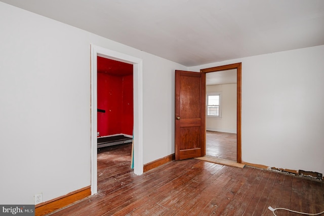 unfurnished room with hardwood / wood-style flooring