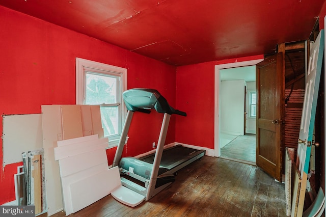 workout room with dark wood-type flooring