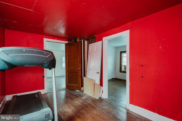 exercise room featuring dark wood-type flooring