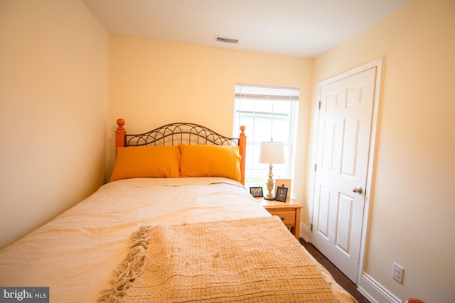 bedroom with baseboards and visible vents