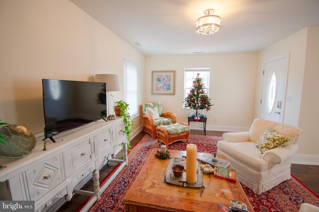 living room featuring wood finished floors and baseboards