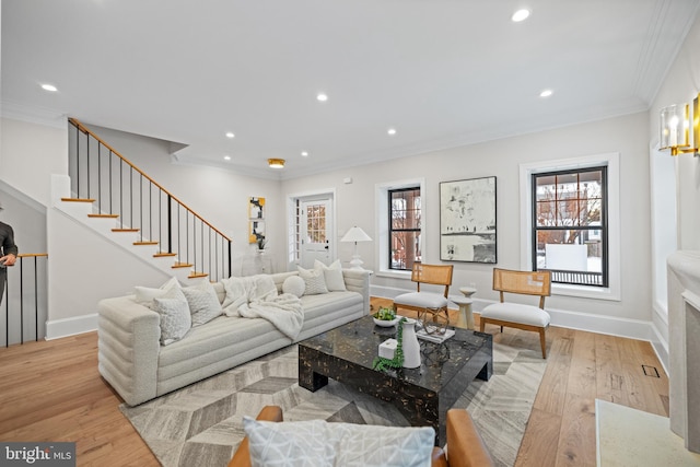 living room with light hardwood / wood-style flooring and ornamental molding