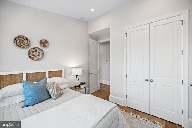 bedroom with hardwood / wood-style floors and a closet