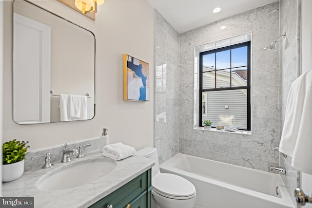 full bathroom with vanity, toilet, and tiled shower / bath