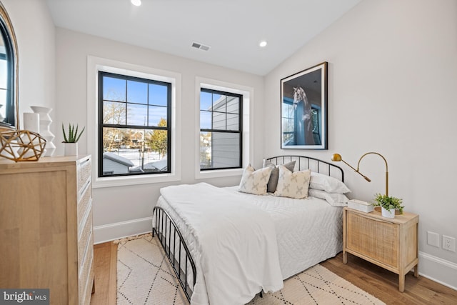 bedroom featuring wood-type flooring and vaulted ceiling