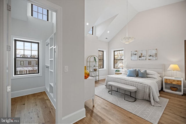 bedroom featuring hardwood / wood-style floors and high vaulted ceiling