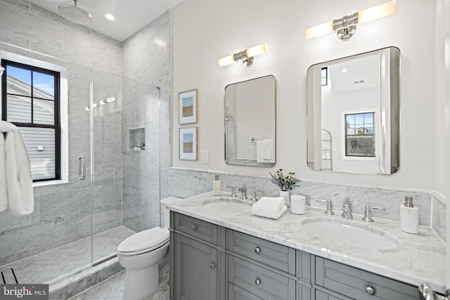 bathroom featuring tile patterned flooring, vanity, toilet, and a shower with door