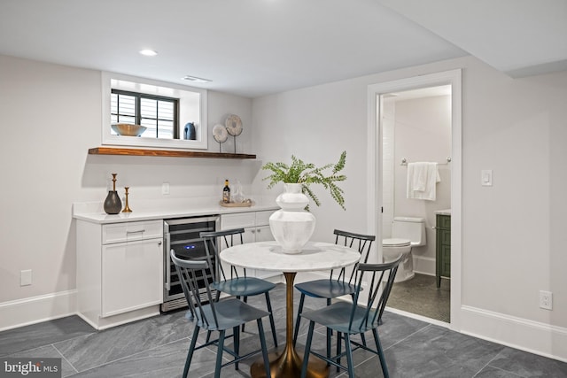 dining room featuring bar and wine cooler