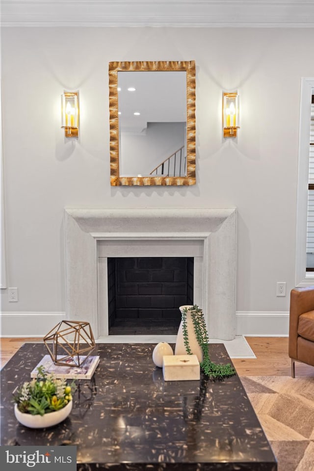 living room with crown molding and hardwood / wood-style flooring