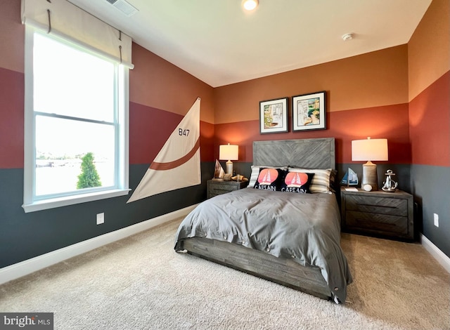 bedroom featuring carpet flooring and multiple windows