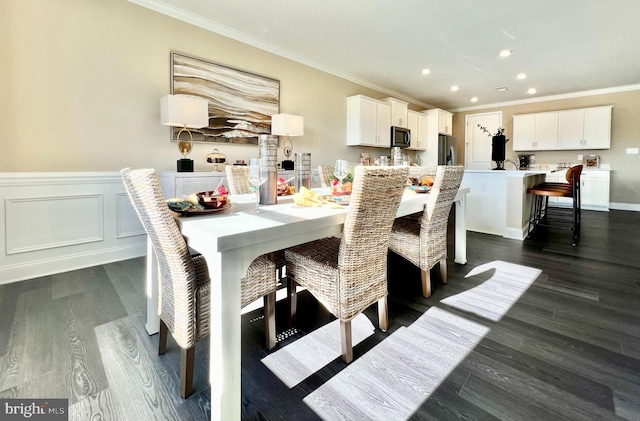 dining area featuring dark hardwood / wood-style flooring and crown molding