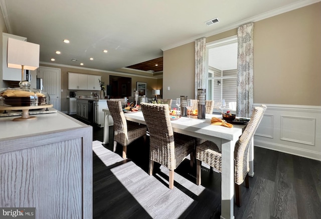 dining space with dark hardwood / wood-style floors and ornamental molding