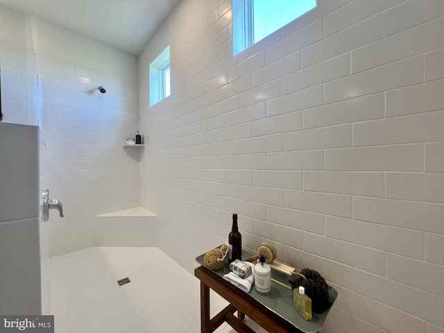 bathroom featuring plenty of natural light and a tile shower