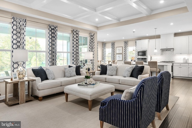 living room featuring beamed ceiling, light hardwood / wood-style floors, and coffered ceiling