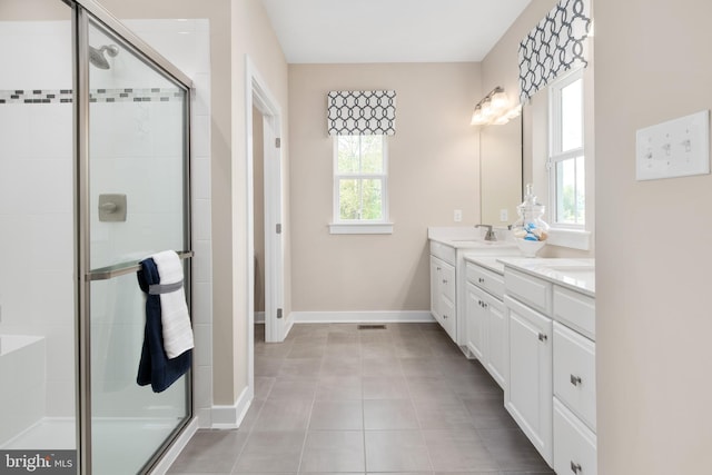 bathroom featuring tile patterned floors, vanity, and an enclosed shower