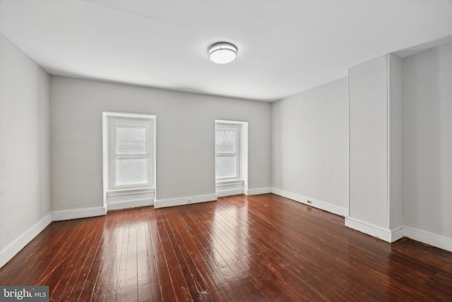 spare room featuring dark wood-type flooring