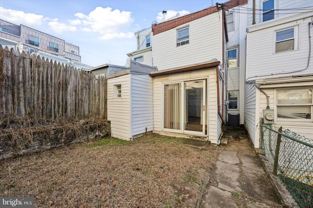 rear view of property with central AC unit