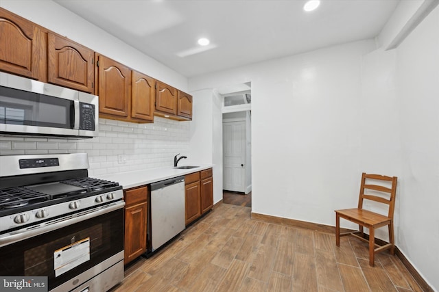 kitchen featuring sink, appliances with stainless steel finishes, and tasteful backsplash