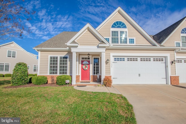 view of front of house with a front yard and a garage