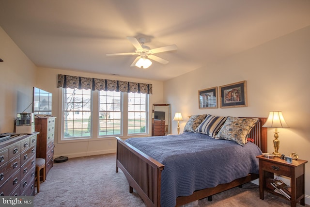 bedroom with ceiling fan and light carpet