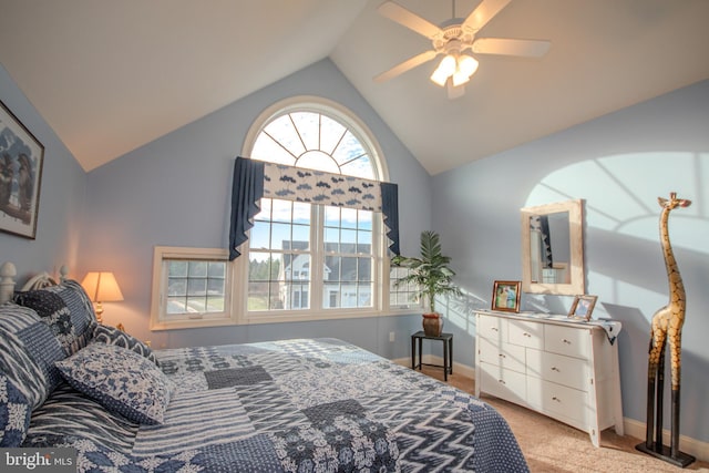 bedroom featuring multiple windows, ceiling fan, light carpet, and lofted ceiling