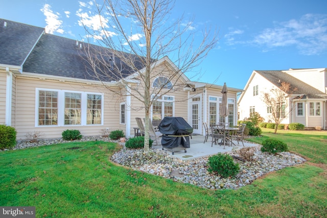 back of property with a patio and a lawn