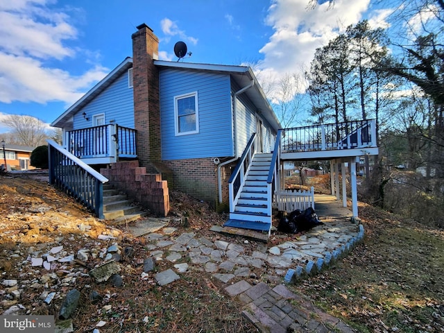 rear view of house featuring a deck