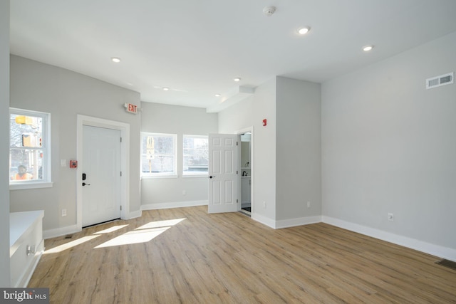 empty room with light hardwood / wood-style flooring