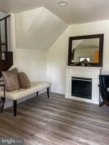 517 S Ave, Bridgeton, NJ 08302 - living area with baseboards, a fireplace, wood finished floors, and lofted ceiling